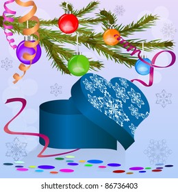 Caja con forma de corazón bajo la rama del árbol de Navidad.