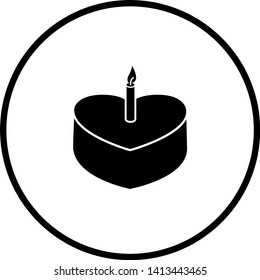 heart shaped cake with lighted candle symbol