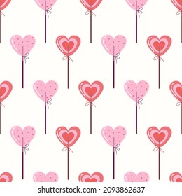 Heart shaped lollipop. Background with sweet candies. Valentine's Day seamless pattern.