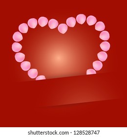 Heart sign made out of pink petals.