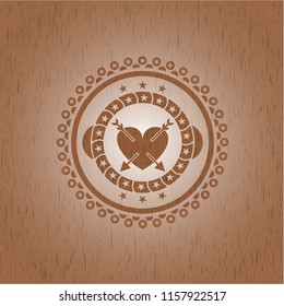 heart with two arrows icon inside wood emblem