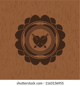heart with two arrows icon inside retro wood emblem