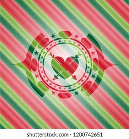 heart with two arrows icon inside christmas colors badge.