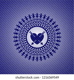 heart with two arrows icon inside emblem with denim high quality background