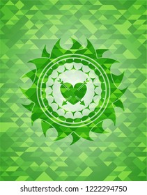 heart with two arrows icon inside realistic green emblem. Mosaic background