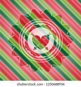 heart with two arrows icon inside christmas colors badge.