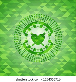 heart with two arrows icon inside realistic green emblem. Mosaic background