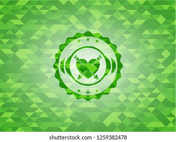 heart with two arrows icon inside realistic green emblem. Mosaic background