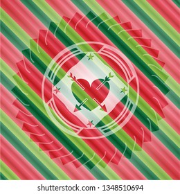 heart with two arrows icon inside christmas colors emblem.