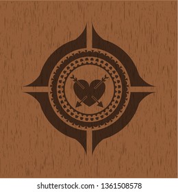 heart with two arrows icon inside vintage wooden emblem