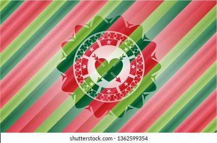 heart with two arrows icon inside christmas colors badge.