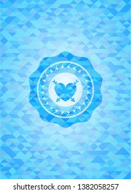 heart with two arrows icon inside sky blue emblem with triangle mosaic background