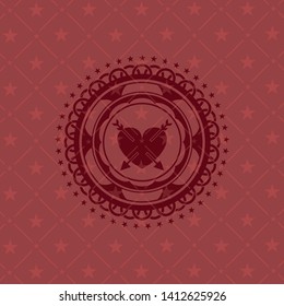 heart with two arrows icon inside red emblem