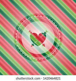 heart with two arrows icon inside christmas style emblem.
