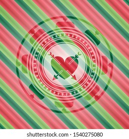 heart with two arrows icon inside christmas colors style emblem.