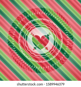 heart with two arrows icon inside christmas colors style emblem.