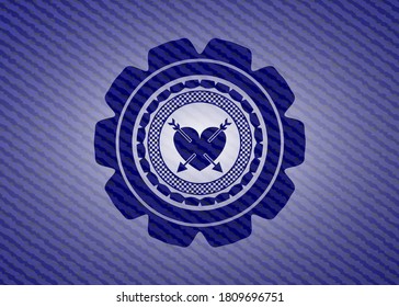 heart with two arrows icon inside badge with denim texture. 