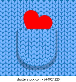 Heart of a valentine in a pocket of a knitted pullover