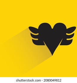 heart and wing with drop shadow on yellow background