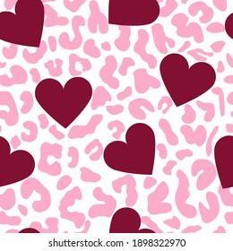 Hearts on a leopard background. Burgundy and pink elements. Bright festive ornament suitable for textiles