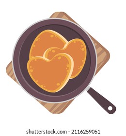 Heart-shaped pancakes in a frying pan. Vector clipart.