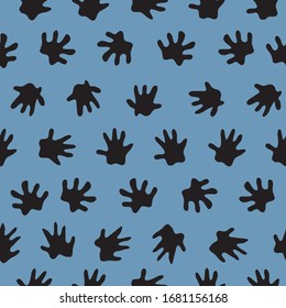 Hedgehog foot prints scattered about making a background. seamless repeat vector black silhouettes on blue. surface pattern design