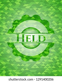 Held realistic green mosaic emblem