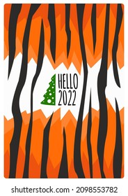 "Hello 2022" text with a small green Christmas tree on the postcard designed as an orange and black skin of a tiger pattern, symbol of the year. 