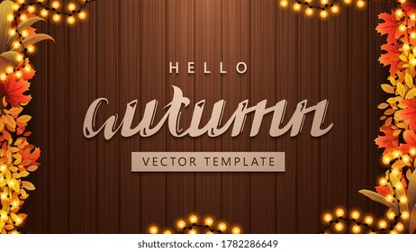 Hello autumn, background template with maple leafs, autumn vegetations, garland frame and brown wooden background, top view. Autumn template for your arts with