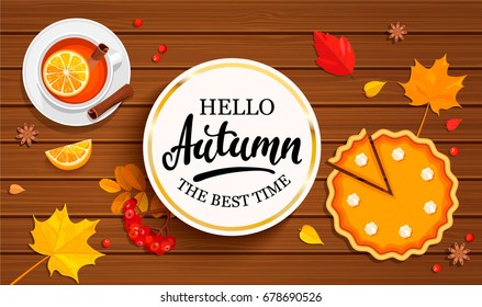 Hello autumn banner in gold frame with pumpkin pie, tea and autumn leaves on wooden background. Vector illustration.