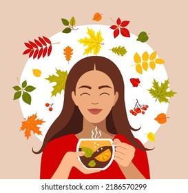 Hello autumn, beautiful girl with wreath of autumn leaves and cup of hot tea.