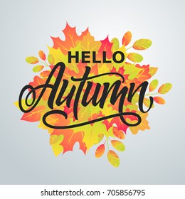 Hello Autumn. Bright abstract background with leaves. Modern handmade vector lettering.