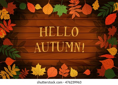 Hello autumn. Hand drawn different colored autumn leaves. Background for your design. On wooden background.