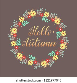 Hello Autumn. Hand lettering  in a flower wreath. Vector illustration.