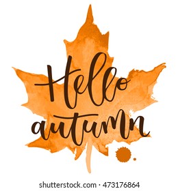 Hello autumn hand written inscription with orange watercolor maple leaf