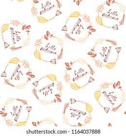 Hello autumn. Hand-drawn seamless pattern with text and colored leaves on white background. Vector drawing.