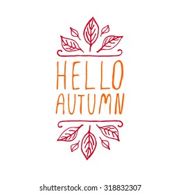 Hello Autumn. Hand-sketched typographic element with autumn leaves on white background. 