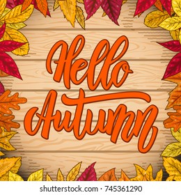 Hello autumn. Lettering quote on wooden background with border from yellow leaves. Design element for poster, card, banner. Vector illustration