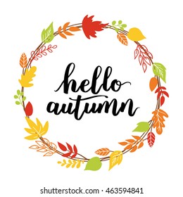 Hello, Autumn. The trend calligraphy. Beautiful round wreath of autumn leaves. Vector illustration on a blue background.