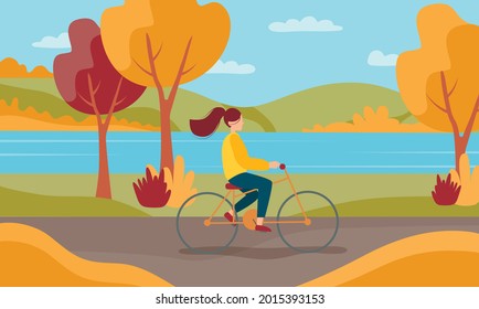 Hello autumn. Young female walking with bicycle in a park.
