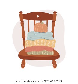 Hello Fall. Sweater weather concept. Sweaters and pumpkin on the chair.
