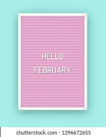 Hello February motivation quote on pink letterboard with white plastic letters