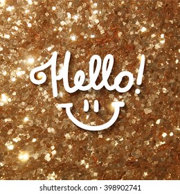 hello, handwritten text and smile on gold tinsel background