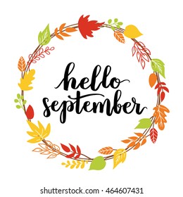 Hello, September. The trend calligraphy. Beautiful round wreath of autumn leaves. Vector illustration on a blue background.