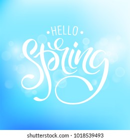 Hello Spring. Background with bokeh and handwritten lettering