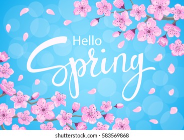 hello spring background with cherry blossoms flowers branches on blue backdrop with bokeh