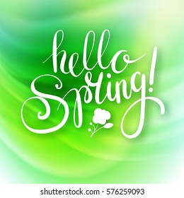 "Hello spring!" Brush Pen lettering on a green blurred background. Handwritten vector Illustration. 