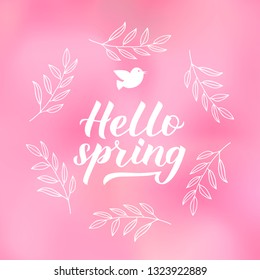 Hello spring calligraphy lettering with floral wreath frame on pink blurred background. Inspirational seasonal quote typography poster. Easy to edit vector template for banner, flyer, badge.