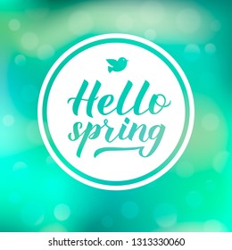 Hello spring calligraphy lettering on green blurred bokeh background. Inspirational seasonal quote typography poster. Easy to edit vector template for banner, flyer, badge. Hand written logo design.