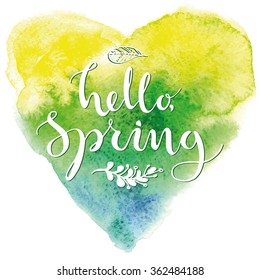 Hello, Spring. Card template with modern calligraphy and hand drawn leaves and flowers on watercolor heart. Handwritten ink lettering.